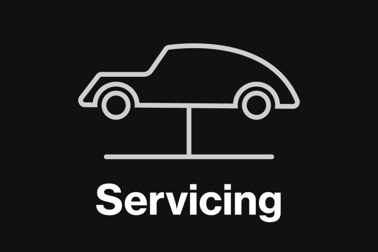 a grey background with a white icon of a car on a ramp and the word 